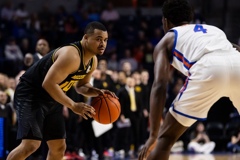 Feb 28, 2024; Gainesville, Florida, USA; Missouri Tigers guard Nick Honor (10) dribbles the ball against Florida Gators forward Tyrese Samuel (4) during the first half at Exactech Arena at the Stephen C. O'Connell Center. Mandatory Credit: Matt Pendleton-USA TODAY Sports