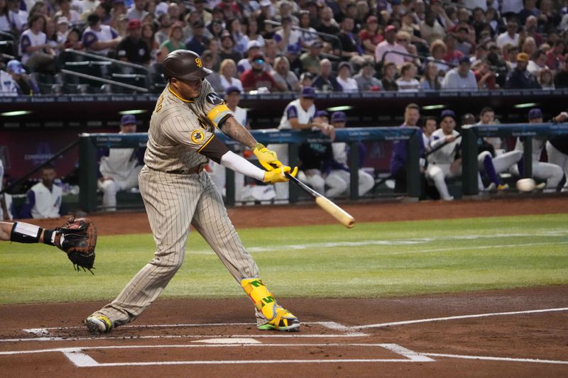 Aug 12, 2023; Phoenix, Arizona, USA; San Diego Padres third baseman Manny Machado (13) hits a single against the Arizona Diamondbacks during the first inning at Chase Field. Mandatory Credit: Joe Camporeale-USA TODAY Sports