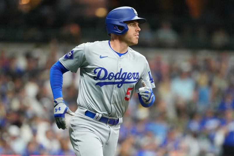 Aug 13, 2024; Milwaukee, Wisconsin, USA;  Los Angeles Dodgers first baseman Freddie Freeman (5) runs towards first base during the seventh inning against the Milwaukee Brewers at American Family Field. Mandatory Credit: Jeff Hanisch-USA TODAY Sports