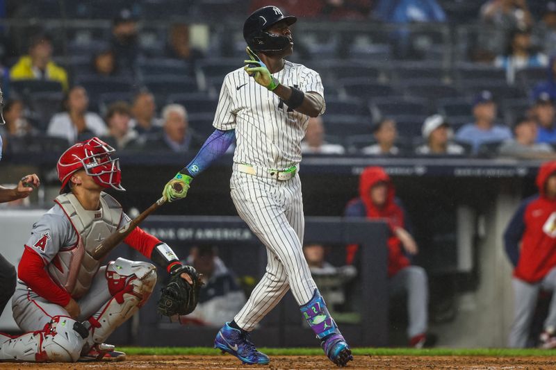 Aug 8, 2024; Bronx, New York, USA;  New York Yankees third baseman Jazz Chisholm Jr. (13) hits a solo home run in the second inning against the Los Angeles Angels at Yankee Stadium. Mandatory Credit: Wendell Cruz-USA TODAY Sports