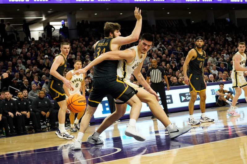 Dec 1, 2023; Evanston, Illinois, USA; Northwestern Wildcats center Matthew Nicholson (34) defends Purdue Boilermakers center Zach Edey (15) during the first half at Welsh-Ryan Arena. Mandatory Credit: David Banks-USA TODAY Sports