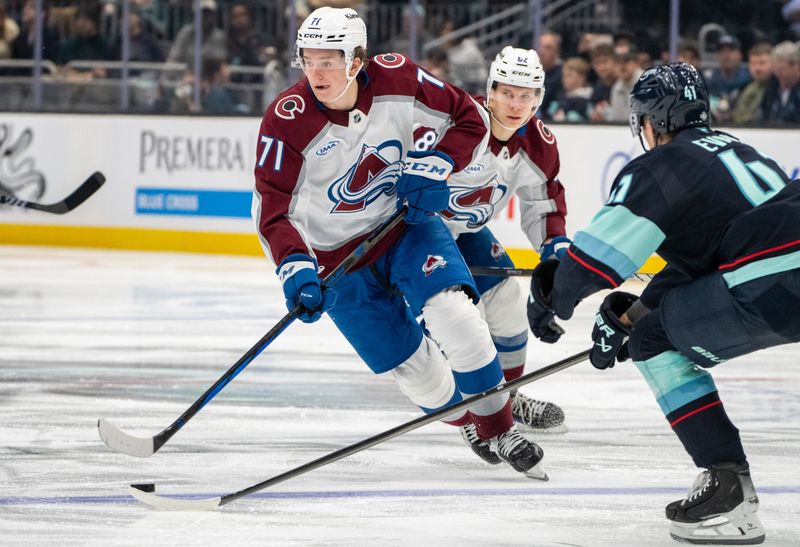 Oct 22, 2024; Seattle, Washington, USA;  Colorado Avalanche forward Calum Ritchie (71) skates against Seattle Kraken defenseman Ryker Evans (41) during the third period at Climate Pledge Arena. Mandatory Credit: Stephen Brashear-Imagn Images