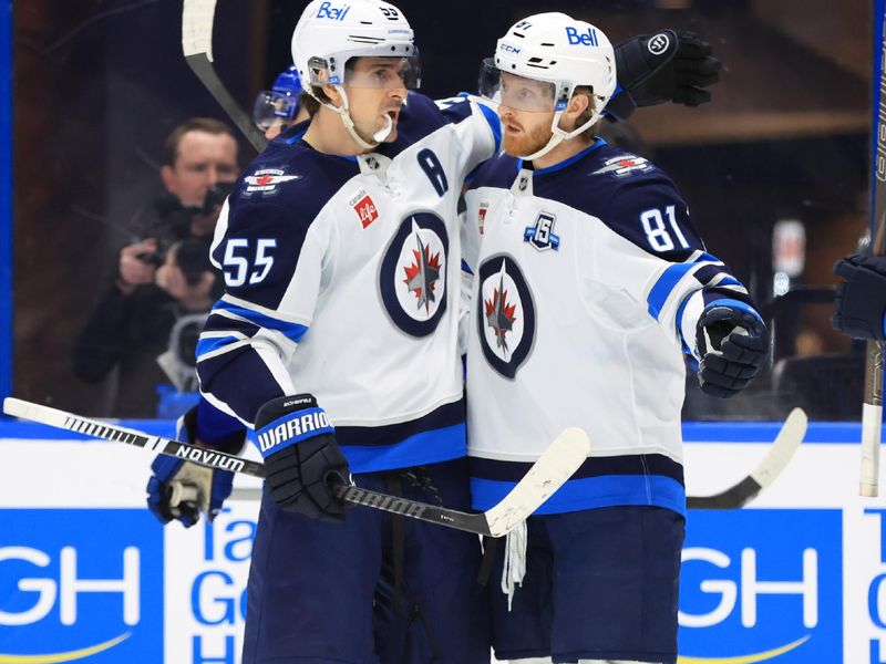 Jan 29, 2026; Tampa, Florida, USA; Winnipeg Jets left wing Kyle Connor (81) is congratulated by center Mark Scheifele (55) after scoring a goal against the Tampa Bay Lightning during the second period at Benchmark International Arena. Mandatory Credit: Kim Klement Neitzel-Imagn Images