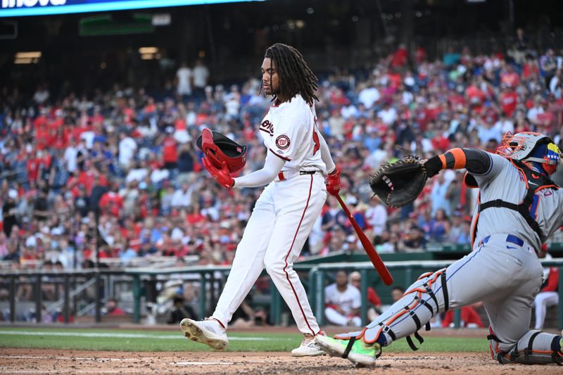 Jul 1, 2024; Washington, District of Columbia, USA; Washington Nationals center fielder James Wood (50) catches his batting helmet after striking out against the New York Mets during the fourth inning at Nationals Park. Mandatory Credit: Rafael Suanes-USA TODAY Sports