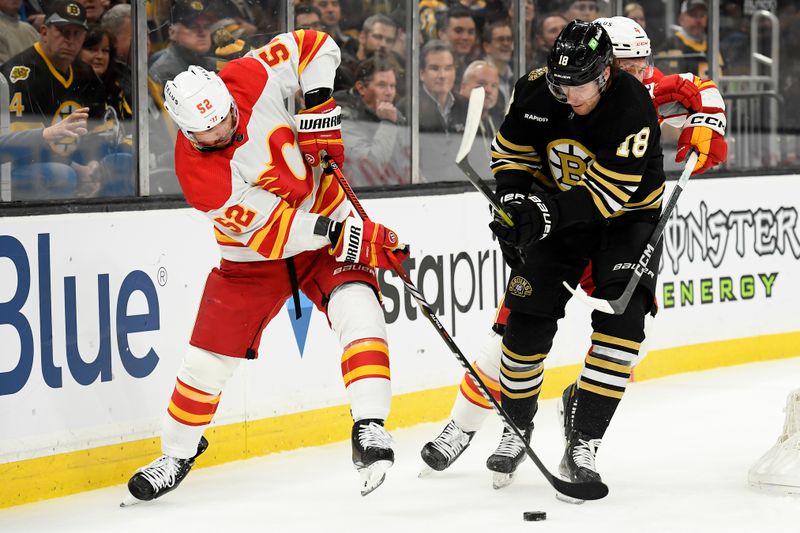 Feb 6, 2024; Boston, Massachusetts, USA; Calgary Flames defenseman MacKenzie Weegar (52) and Boston Bruins center Pavel Zacha (18) battle for the puck during the first period at TD Garden. Mandatory Credit: Bob DeChiara-USA TODAY Sports