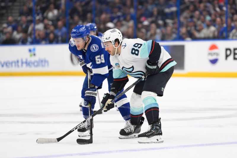 Mar 26, 2026; Tampa, Florida, USA; Tampa Bay Lightning Jake Guentzel (59) battle against Seattle Kraken Freddy Gaudreau (89) at Benchmark International Arena. Mandatory Credit: Pablo Robles-Imagn Images