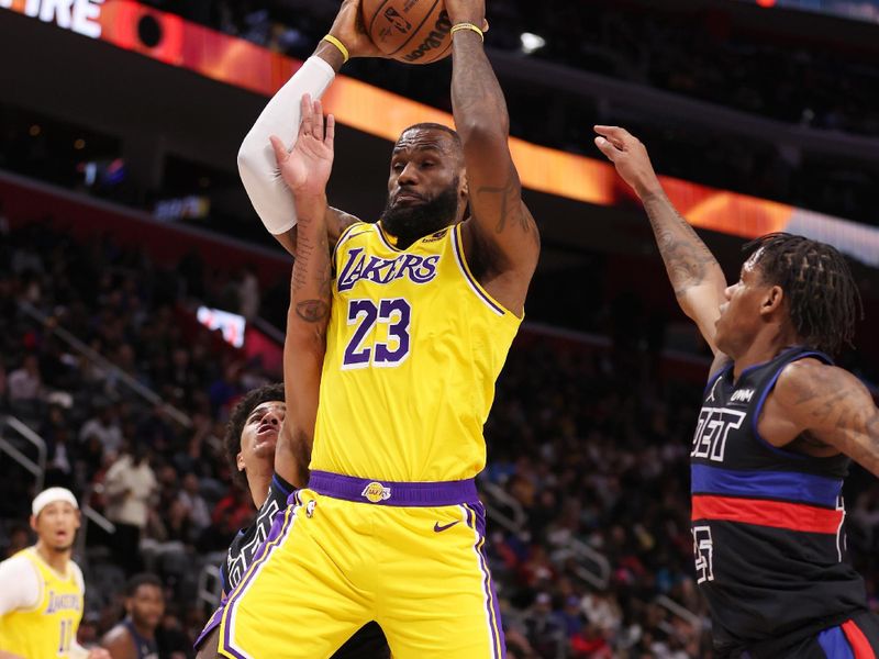 DETROIT, MICHIGAN - NOVEMBER 29: LeBron James #23 of the Los Angeles Lakers grabs a first half rebound between Marcus Sasser #25 and Killian Hayes #7 of the Detroit Pistons at Little Caesars Arena on November 29, 2023 in Detroit, Michigan. NOTE TO USER: User expressly acknowledges and agrees that, by downloading and or using this photograph, User is consenting to the terms and conditions of the Getty Images License Agreement. (Photo by Gregory Shamus/Getty Images)