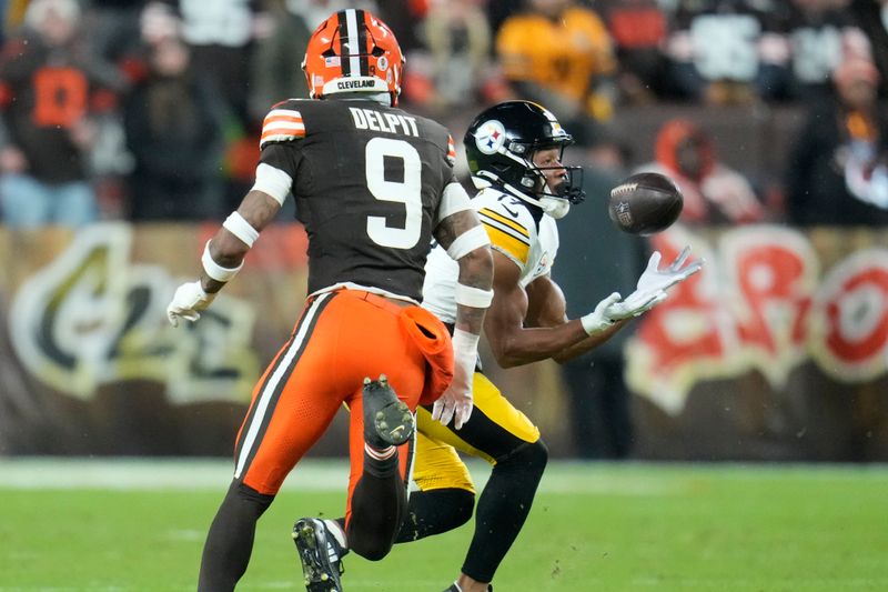 Pittsburgh Steelers wide receiver Calvin Austin III pulls in a pass against Cleveland Browns safety Grant Delpit (9) in the first half of an NFL football game, Thursday, Nov. 21, 2024, in Cleveland. (AP Photo/Sue Ogrocki)