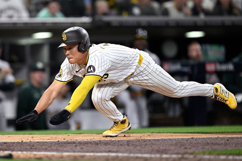 Jun 11, 2024; San Diego, California, USA; San Diego Padres shortstop Ha-Seong Kim (7) dives home to score a run against the Oakland Athletics during the fifth inning at Petco Park. Mandatory Credit: Orlando Ramirez-USA TODAY Sports