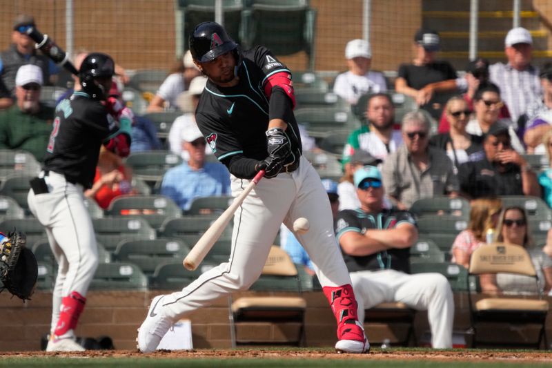 Feb 27, 2024; Salt River Pima-Maricopa, Arizona, USA; Arizona Diamondbacks third baseman Eugenio Suarez (28) hits a single against the Texas Rangers during the second inning at Salt River Fields at Talking Stick. Mandatory Credit: Rick Scuteri-USA TODAY Sports