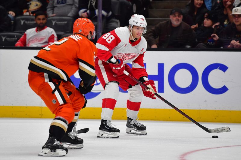 Nov 15, 2024; Anaheim, California, USA; Detroit Red Wings right wing Patrick Kane (88) moves the puck against Anaheim Ducks defenseman Jackson LaCombe (2) during the third period at Honda Center. Mandatory Credit: Gary A. Vasquez-Imagn Images