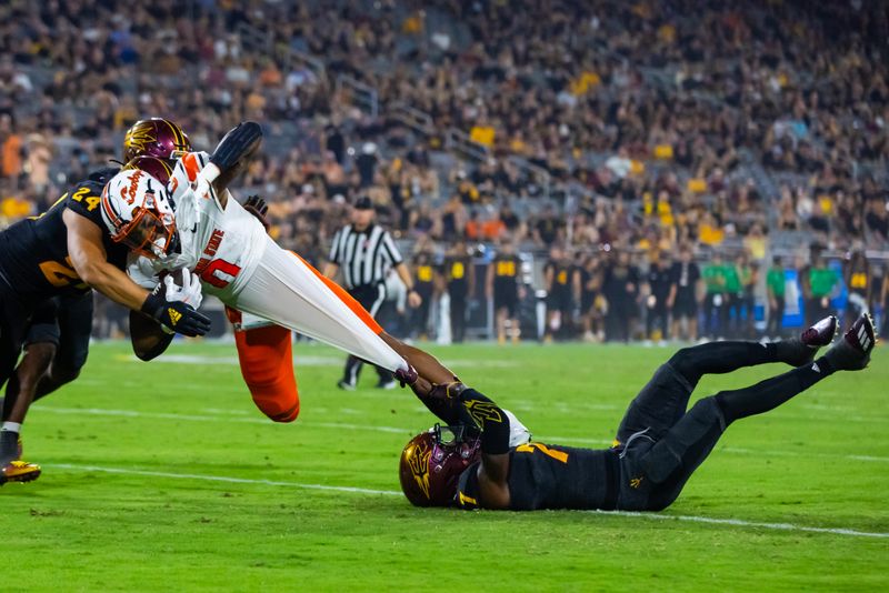 Sep 9, 2023; Tempe, Arizona, USA; Arizona State Sun Devils defensive back Shamari Simmons (7) tackles Oklahoma State Cowboys running back Ollie Gordon II (0) by his stretched undershirt in the second half at Mountain America Stadium. Mandatory Credit: Mark J. Rebilas-USA TODAY Sports