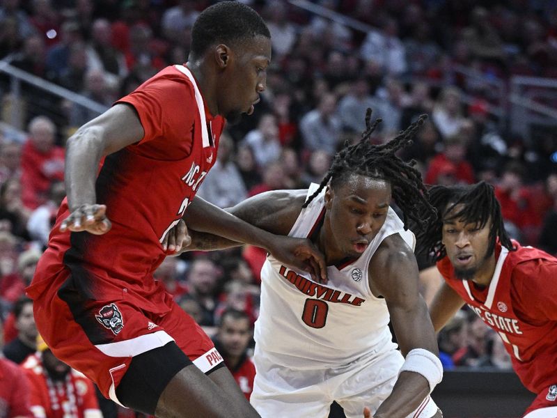 Jan 13, 2024; Louisville, Kentucky, USA;  Louisville Cardinals guard Mike James (0) dribbles against North Carolina State Wolfpack forward Mohamed Diarra (23) during the second half at KFC Yum! Center. Mandatory Credit: Jamie Rhodes-USA TODAY Sports