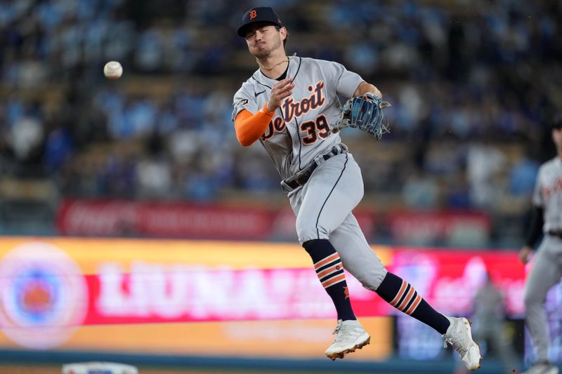 Sep 20, 2023; Los Angeles, California, USA; Detroit Tigers shortstop Zach McKinstry (39) throws to first base in the eighth inning against the Los Angeles Dodgers at Dodger Stadium. Mandatory Credit: Kirby Lee-USA TODAY Sports