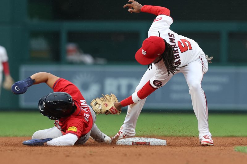 Sep 16, 2025; Washington, District of Columbia, USA; Washington Nationals shortstop CJ Abrams (5) attempts to tag out Atlanta Braves shortstop Ha-Seong Kim (9) at second base on a pickoff attempt during the eighth inning at Nationals Park. Mandatory Credit: Geoff Burke-Imagn Images