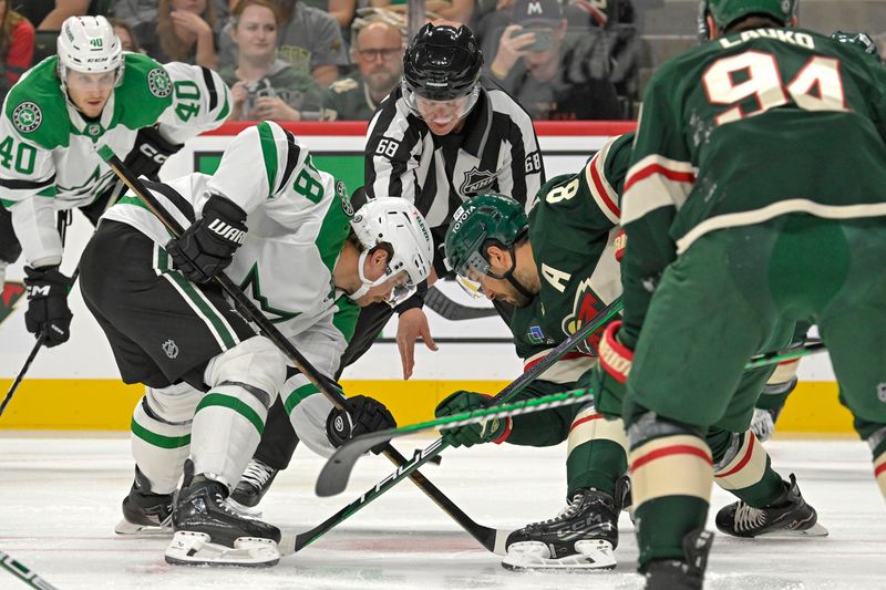 Sep 29, 2024; Saint Paul, Minnesota, USA;  Dallas Stars forward Sam Steel (18) and Minnesota Wild forward Frederick Gaudreau (89) face-off during the first period at Xcel Energy Center. Mandatory Credit: Nick Wosika-Imagn Images