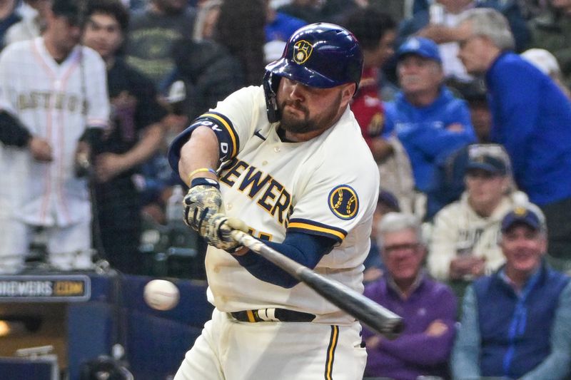 May 24, 2023; Milwaukee, Wisconsin, USA; Milwaukee Brewers first baseman Rowdy Tellez (11) hits a single in the fourth inning during game against the Houston Astros at American Family Field. Mandatory Credit: Benny Sieu-USA TODAY Sports