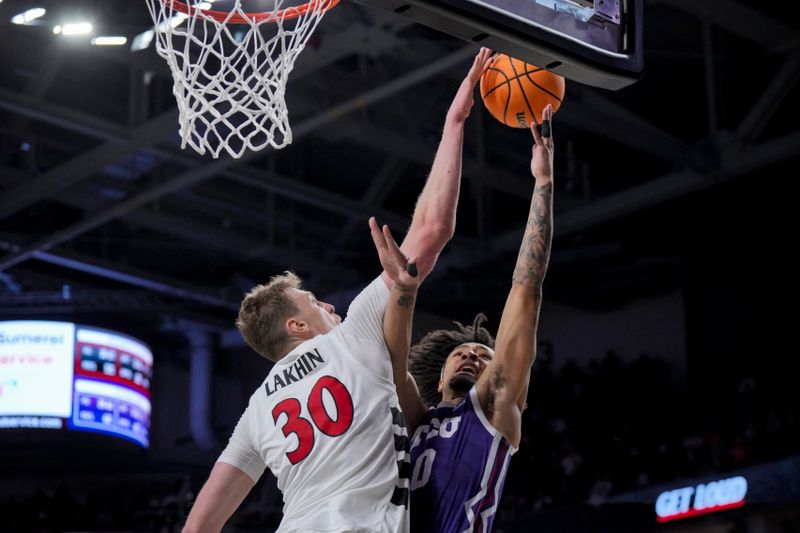 Jan 16, 2024; Cincinnati, Ohio, USA;  Cincinnati Bearcats forward Viktor Lakhin (30) blocks the shot from TCU Horned Frogs guard Micah Peavy (0) in overtime at Fifth Third Arena. Mandatory Credit: Aaron Doster-USA TODAY Sports