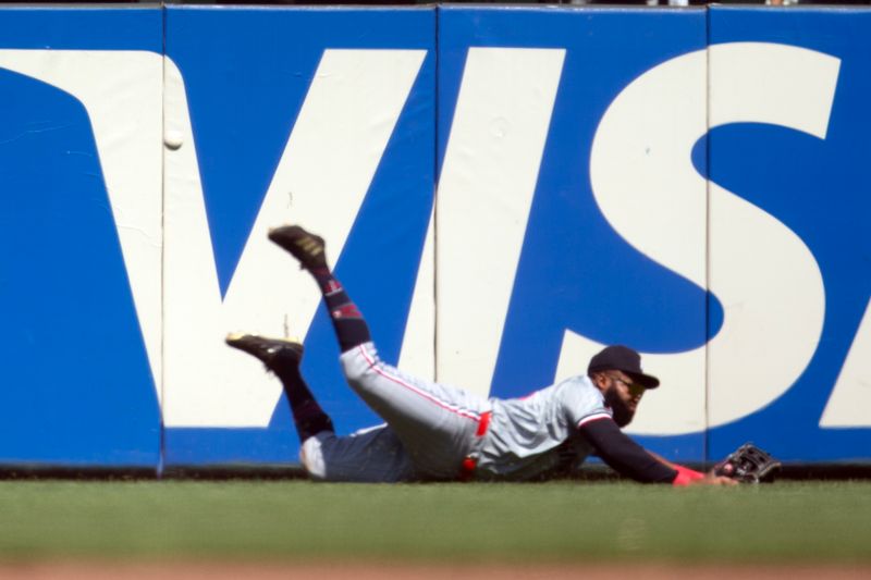 Jul 14, 2024; San Francisco, California, USA; Minnesota Twins center fielder Manuel Margot (13) dives and misses the catch from a triple off the bat of San Francisco Giants right fielder Mike Yastrzemski during the ninth inning at Oracle Park. Mandatory Credit: D. Ross Cameron-USA TODAY Sports