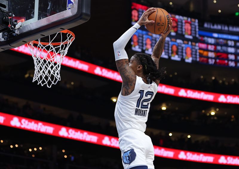 ATLANTA, GEORGIA - DECEMBER 23:  Ja Morant #12 of the Memphis Grizzlies dunks against the Atlanta Hawks during the third quarter at State Farm Arena on December 23, 2023 in Atlanta, Georgia.  NOTE TO USER: User expressly acknowledges and agrees that, by downloading and/or using this photograph, user is consenting to the terms and conditions of the Getty Images License Agreement. (Photo by Kevin C. Cox/Getty Images)