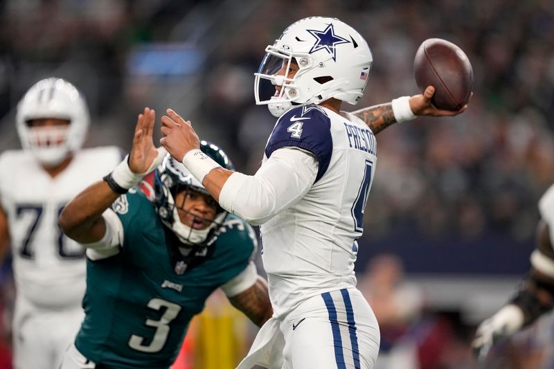 Dallas Cowboys quarterback Dak Prescott (4) attempts a pass with pressure from Philadelphia Eagles linebacker Nolan Smith (3) during the first half of an NFL football game, Sunday, Dec. 10, 2023, in Arlington, Texas. (AP Photo/Sam Hodde)