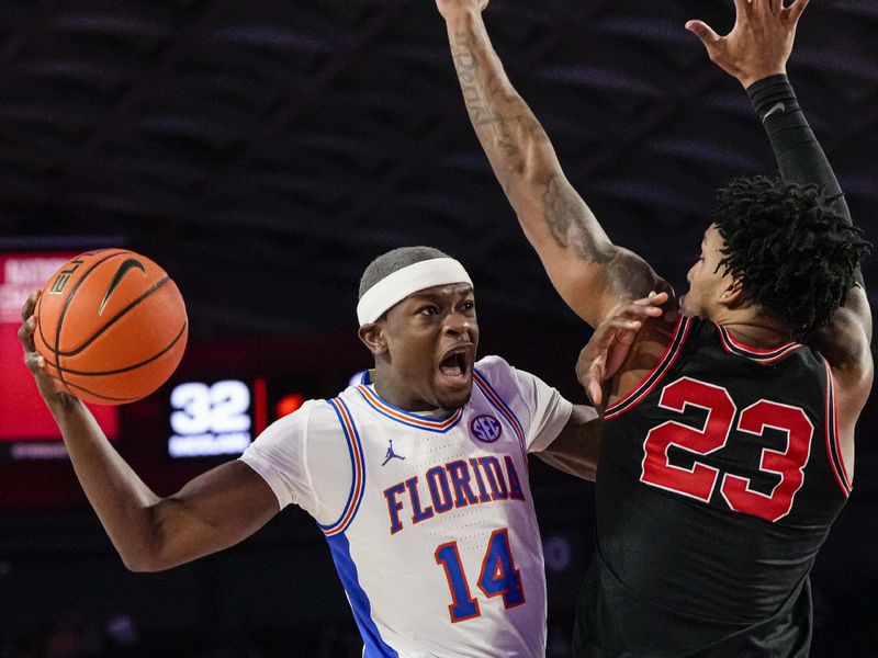 Feb 28, 2023; Athens, Georgia, USA; Florida Gators guard Kowacie Reeves (14) tries to score against Georgia Bulldogs center Braelen Bridges (23) during the first half at Stegeman Coliseum. Mandatory Credit: Dale Zanine-USA TODAY Sports