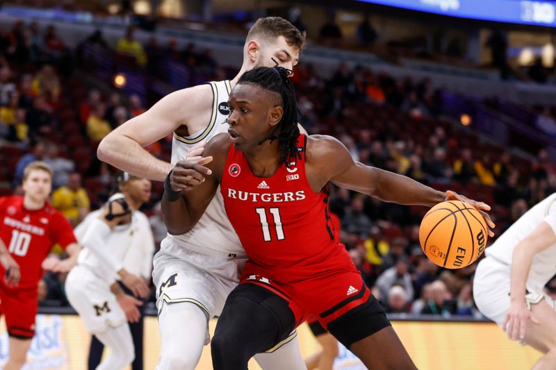 Mar 9, 2023; Chicago, IL, USA; Rutgers Scarlet Knights center Clifford Omoruyi (11) drives to the basket against Michigan Wolverines center Hunter Dickinson (1) during the first half at United Center. Mandatory Credit: Kamil Krzaczynski-USA TODAY Sports