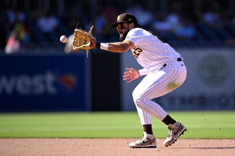 Sep 6, 2023; San Diego, California, USA; San Diego Padres  second baseman Fernando Tatis Jr. (23) fields a ground ball during the ninth inning against the Philadelphia Phillies at Petco Park. Mandatory Credit: Orlando Ramirez-USA TODAY Sports