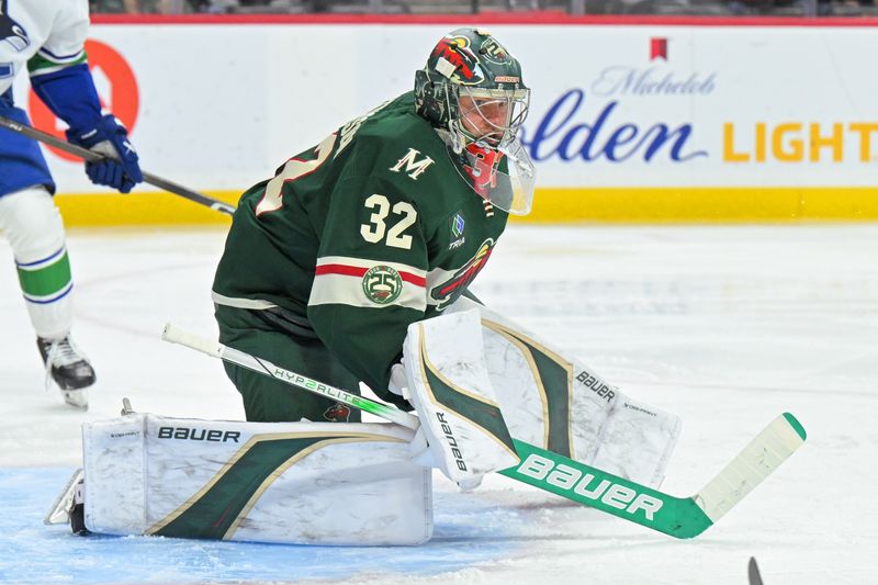 Nov 1, 2025; Saint Paul, Minnesota, USA;  Minnesota Wild goalie Filip Gustavsson (32) tracks the puck against the Vancouver Canucks during the third period at Grand Casino Arena. Mandatory Credit: Nick Wosika-Imagn Images