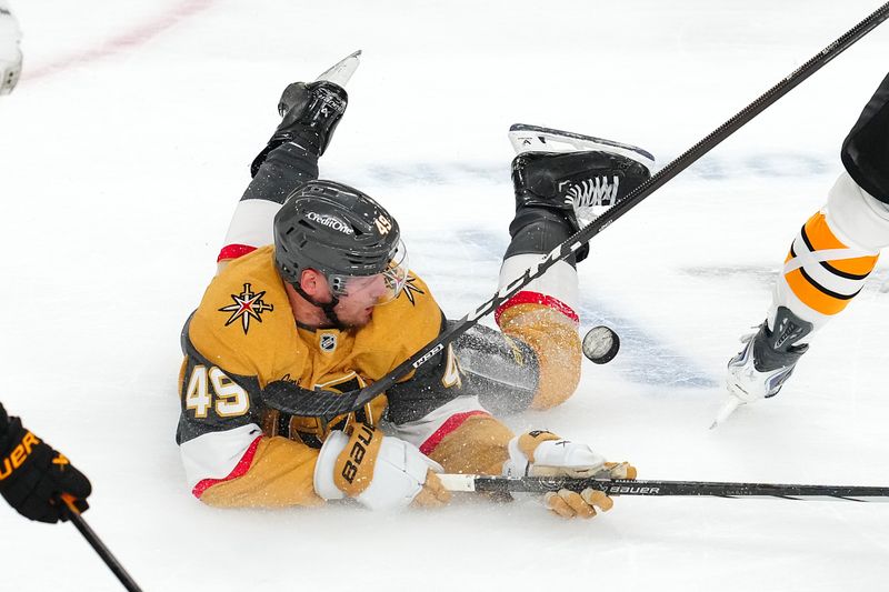 Oct 16, 2025; Las Vegas, Nevada, USA; Vegas Golden Knights left wing Ivan Barbashev (49) is upended by a Boston Bruins player during the third period at T-Mobile Arena. Mandatory Credit: Stephen R. Sylvanie-Imagn Images