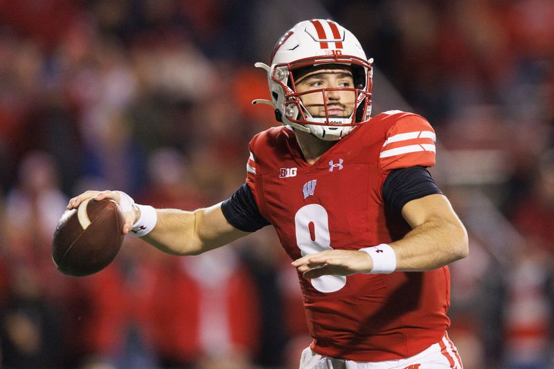 Nov 18, 2023; Madison, Wisconsin, USA;  Wisconsin Badgers quarterback Tanner Mordecai (8) throws a pass during the first quarter against the Nebraska Cornhuskers at Camp Randall Stadium. Mandatory Credit: Jeff Hanisch-USA TODAY Sports