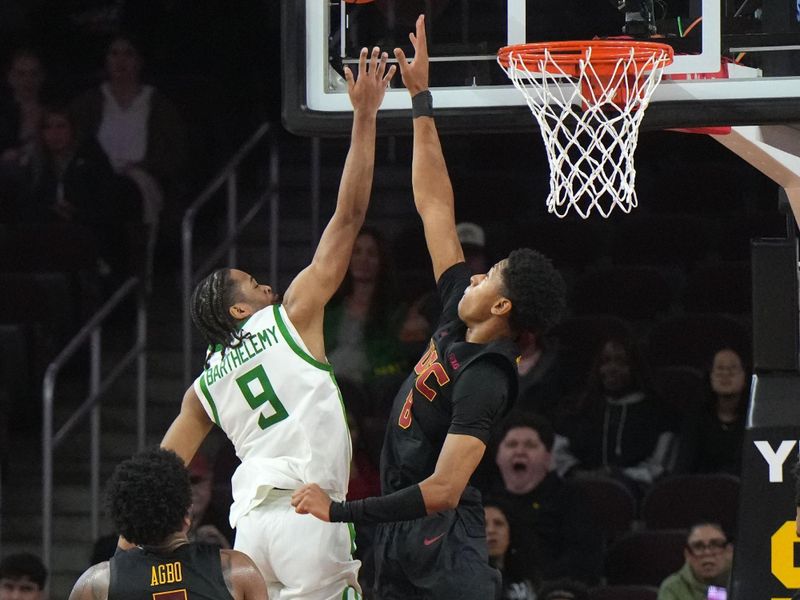 Dec 4, 2024; Los Angeles, California, USA; Southern California Trojans forward Terrance Williams II (5) blocks a shot by Oregon Ducks guard TJ Bamba (5) in the first half at Galen Center. Mandatory Credit: Kirby Lee-Imagn Images