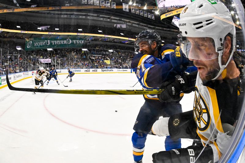 Nov 12, 2024; St. Louis, Missouri, USA;  St. Louis Blues defenseman Pierre-Olivier Joseph (77) checks Boston Bruins center Pavel Zacha (18) during the first period at Enterprise Center. Mandatory Credit: Jeff Curry-Imagn Images