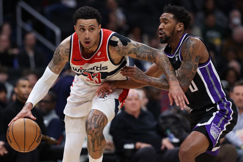 WASHINGTON, DC - MARCH 21: Kyle Kuzma #33 of the Washington Wizards dribbles in front of Malik Monk #0 of the Sacramento Kings during the first half at Capital One Arena on March 21, 2024 in Washington, DC. NOTE TO USER: User expressly acknowledges and agrees that, by downloading and or using this photograph, User is consenting to the terms and conditions of the Getty Images License Agreement. (Photo by Patrick Smith/Getty Images)