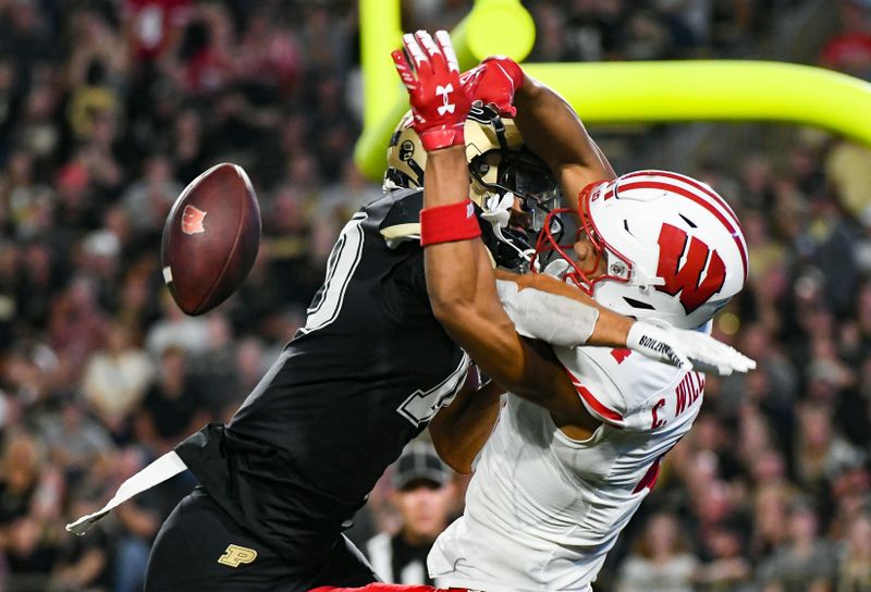 Sep 22, 2023; West Lafayette, Indiana, USA; Purdue Boilermakers defensive back Cam Allen (10) breaks up a pass intended for Wisconsin Badgers wide receiver C.J. Williams (4) during the second half at Ross-Ade Stadium. Mandatory Credit: Robert Goddin-USA TODAY Sports