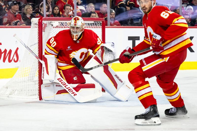 Dec 5, 2024; Calgary, Alberta, CAN; Calgary Flames goaltender Daniel Vladar (80) keeps his eye on the play during the first period against the St. Louis Blues at Scotiabank Saddledome. Mandatory Credit: Brett Holmes-Imagn Images