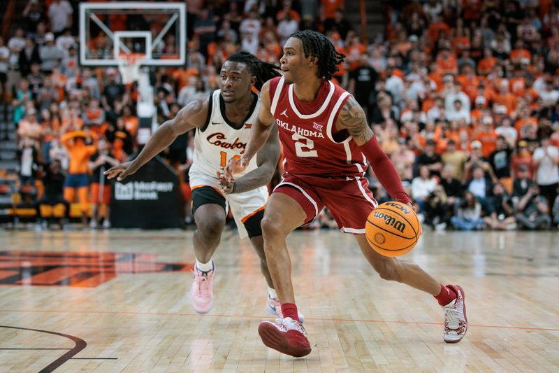 Feb 24, 2024; Stillwater, Oklahoma, USA; Oklahoma State Cowboys forward Eric Dailey Jr. (2) drives around Oklahoma State Cowboys guard Jamyron Keller (14) during the second half at Gallagher-Iba Arena. Mandatory Credit: William Purnell-USA TODAY Sports