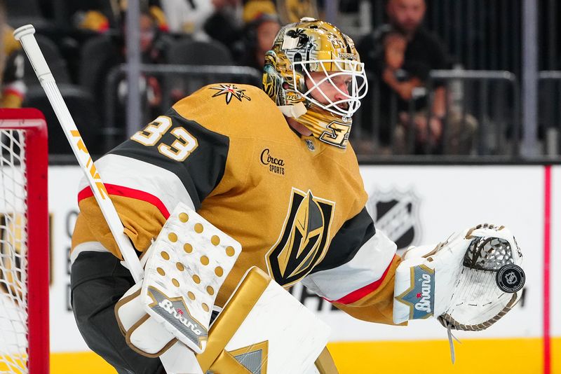 Oct 11, 2024; Las Vegas, Nevada, USA; Vegas Golden Knights goaltender Adin Hill (33) warms up before a game against the St. Louis Blues at T-Mobile Arena. Mandatory Credit: Stephen R. Sylvanie-Imagn Images