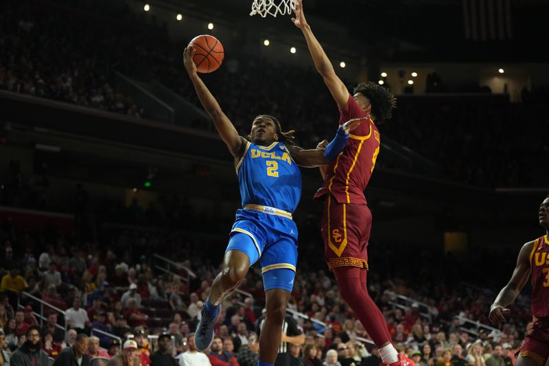 Jan 27, 2024; Los Angeles, California, USA; UCLA Bruins guard Dylan Andrews (2) shoots the ball against Southern California Trojans guard Oziyah Sellers (4) in the first half at Galen Center. Mandatory Credit: Kirby Lee-USA TODAY Sports