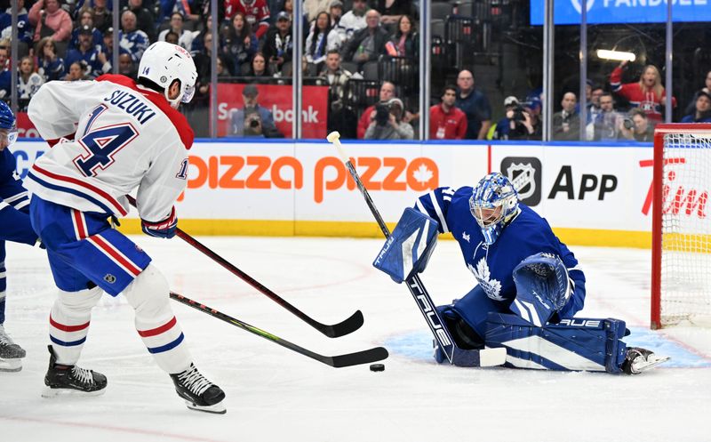 Apr 12, 2025; Toronto, Ontario, CAN;  Toronto Maple Leafs goalie Anthony Stolarz (41) makes a save on Montreal Canadiens forward Nick Suzuki (14) in the second period at Scotiabank Arena. Mandatory Credit: Dan Hamilton-Imagn Images