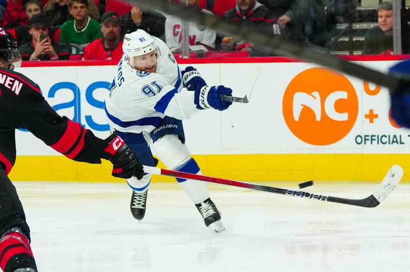 Nov 24, 2023; Raleigh, North Carolina, USA; Tampa Bay Lightning center Steven Stamkos (91) scores a goal against the Carolina Hurricanes during the second period at PNC Arena. Mandatory Credit: James Guillory-USA TODAY Sports