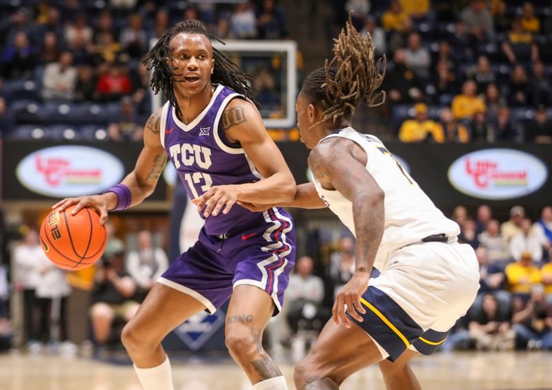 Feb 25, 2025; Morgantown, West Virginia, USA; TCU Horned Frogs forward Trazarien White (13) dribbles against West Virginia Mountaineers guard Javon Small (7) during the second half at WVU Coliseum. Mandatory Credit: Ben Queen-Imagn Images