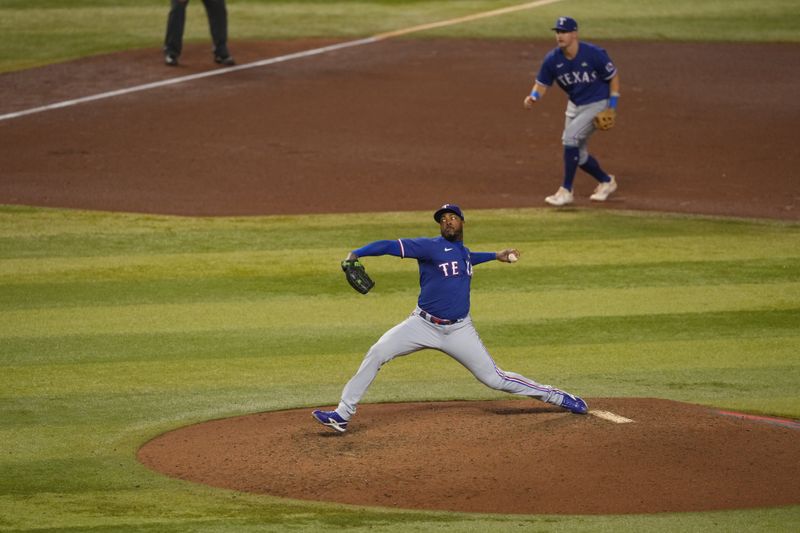 Nov 1, 2023; Phoenix, AZ, USA; Texas Rangers relief pitcher Aroldis Chapman (45) pitches in the in the seventh inning against the Arizona Diamondbacks  in game five of the 2023 World Series at Chase Field. Mandatory Credit: Joe Camporeale-USA TODAY Sports