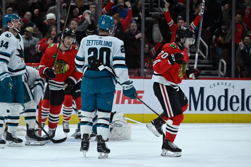 Jan 16, 2024; Chicago, Illinois, USA; Chicago Blackhawks center Cole Guttman (70), right, reacts after scoring a goal against the San Jose Sharks during the first period at United Center. Mandatory Credit: Matt Marton-USA TODAY Sports