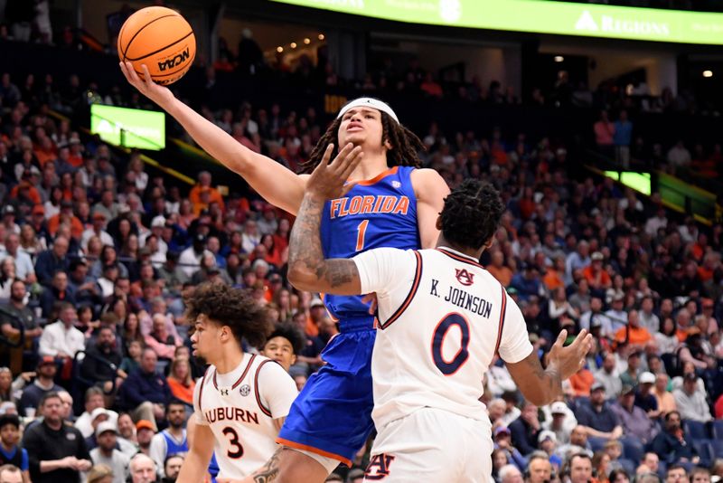 Mar 17, 2024; Nashville, TN, USA; Florida Gators guard Walter Clayton Jr. (1) shoots against Auburn Tigers guard K.D. Johnson (0) in the first half in the SEC Tournament championship game at Bridgestone Arena. Mandatory Credit: Steve Roberts-USA TODAY Sports