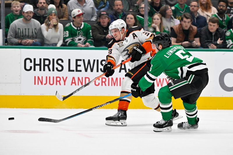 Jan 25, 2024; Dallas, Texas, USA; Anaheim Ducks right wing Jakob Silfverberg (33) shoots the puck past Dallas Stars defenseman Nils Lundkvist (5) during the first period at the American Airlines Center. Mandatory Credit: Jerome Miron-USA TODAY Sports