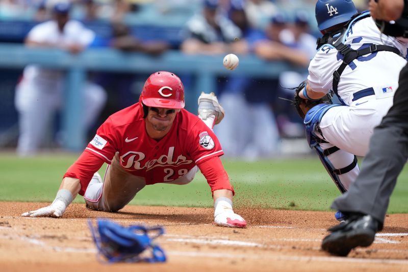 Jul 30, 2023; Los Angeles, California, USA; Cincinnati Reds center fielder TJ Friedl (29) slides into home plate to beat a throw to Los Angeles Dodgers catcher Will Smith (16) to score in the first inning at Dodger Stadium. Mandatory Credit: Kirby Lee-USA TODAY Sports