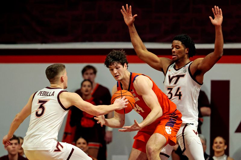 Jan 10, 2024; Blacksburg, Virginia, USA; Virginia Tech Hokies guard Sean Pedulla (3) steals the ball against Clemson Tigers center PJ Hall (24) during the second half at Cassell Coliseum. Mandatory Credit: Peter Casey-USA TODAY Sports