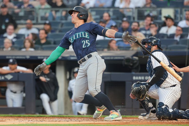 May 21, 2024; Bronx, New York, USA; Seattle Mariners shortstop Dylan Moore (25) hits a two run home run during the third inning against the New York Yankees at Yankee Stadium. Mandatory Credit: Vincent Carchietta-USA TODAY Sports