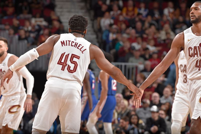 CLEVELAND, OH - MARCH 29: Donovan Mitchell #45 of the Cleveland Cavaliers high fives Evan Mobley #4 during the game against the Philadelphia 76ers on March 29, 2024 at Rocket Mortgage FieldHouse in Cleveland, Ohio. NOTE TO USER: User expressly acknowledges and agrees that, by downloading and/or using this Photograph, user is consenting to the terms and conditions of the Getty Images License Agreement. Mandatory Copyright Notice: Copyright 2024 NBAE (Photo by David Liam Kyle/NBAE via Getty Images)